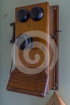 Antique wooden crank telephone on the wall