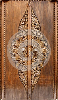 Antique wooden door with floral carvings