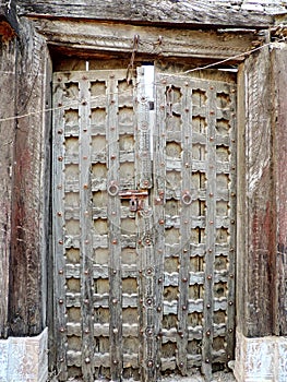 Antique wooden door in Indian village photo