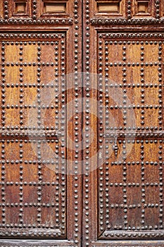 Antique wooden door with iron inlays. Arquitecture background