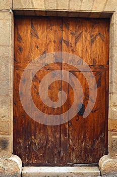 Antique wooden door with wrought iron handle, old wood texture,