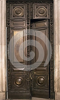 Antique wooden massive half opened door with carved wooden ornament