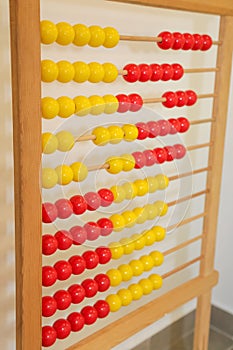 Antique wooden red and yellow abacus isolated in classroom