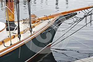 Antique wooden sailboat tied to dock