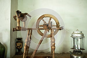 An antique wooden spinning wheel in the barn.