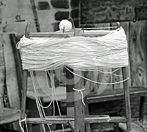 antique wooden spinning wheel with the skein of wool below and t