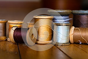 Antique wooden spools of thread in warm colors