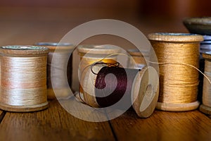 Antique wooden spools of thread in warm colors