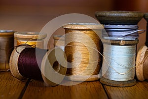 Antique wooden spools of thread in warm colors