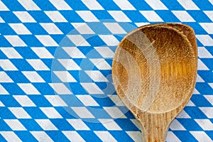 Antique wooden spoon for cooking with blue white background