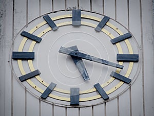 Antique wooden wall clock, installed on the old building wall.