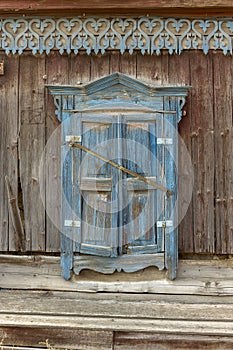 Antique wooden windows carved platbands in the village