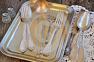 Antiques - cutlery, spoons, forks, knives on a tray