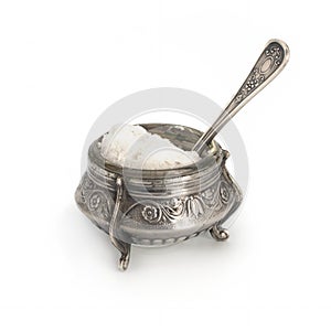 Antiques silver saltcellar with silver spoon photo