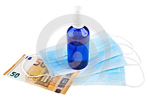 Antiseptic spray, blue medical face masks and 50 Euro banknote isolated on white background