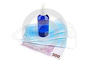 Antiseptic spray, blue medical face masks and 500 Euro banknote isolated on white background