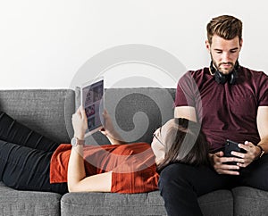 Antisocial couple relaxing on the sofa photo