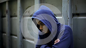 Antisocial teenager hiding from people, protesting against rules and injustice photo