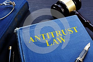 Antitrust law book and gavel on a desk.