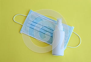 Antiviral medical mask and spray antiseptic bottle for protect against the virus , surgical blue mask on colorful lime background