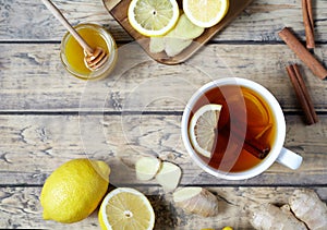 Antiviral useful drink ginger tea. Healthy . With lemon, honey and slices of on wooden table.