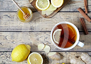 Antiviral useful drink ginger tea. Healthy . With lemon, honey and slices of on wooden table. photo