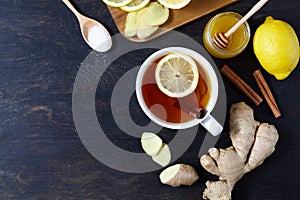 Antiviral useful drink ginger tea. With lemon, honey and slices on wooden table. Rustic Style. View from above.