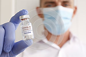 Antiviral vaccine vial in hands of a doctor.