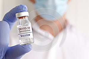 Antiviral vaccine vial in hands of a doctor.