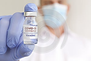 Antiviral vaccine vial in hands of a doctor.