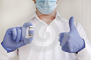 Antiviral vaccine vial in hands of a doctor.