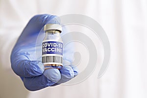 Antiviral vaccine vial in hands of a doctor.