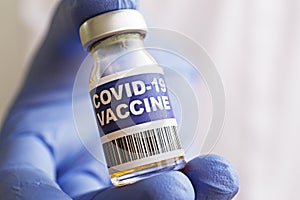 Antiviral vaccine vial in hands of a doctor.