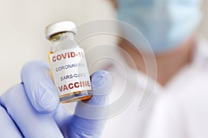 Antiviral vaccine vial in hands of a doctor.