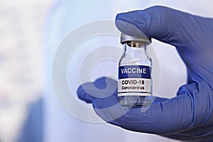 Antiviral vaccine vial in hands of a doctor.