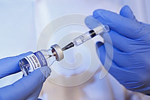 Antiviral vaccine vial in hands of a doctor.