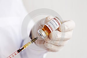 Antiviral vaccine vial in hands of a doctor.