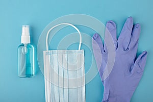 Antivirus protection - medical mask, disposable gloves and antiseptic gel on a blue background