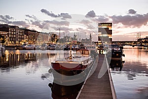 Antwerp, Belgium, beautiful night view of modern Eilandje area and port. Small island district and sailing marine at sunset. Popul