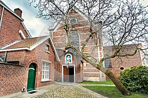 Green courtyard of monastery in historical city area, 13th century Beguinage houses for beguines women