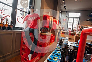 Dummy in red t-shirt inside souvenir and beer store of historical brewery with trademark De Koninck