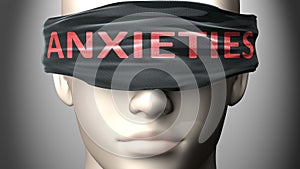 Anxieties can make things harder to see or makes us blind to the reality - pictured as word Anxieties on a blindfold to symbolize photo