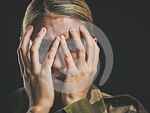 Anxiety, depression and soldier woman crying on dark studio background. Mental health, psychology and stress portrait of