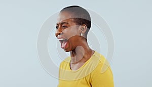 Anxiety, stress and angry black woman screaming in studio with broken heart, grief or fear on grey background