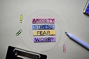 Anxiety - Stress - Fear - Worry text on sticky notes with office desk concept