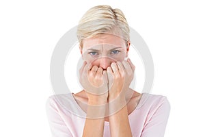 Anxious blonde woman looking at camera