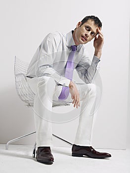 Anxious Businessman Sitting In Swivel Chair photo