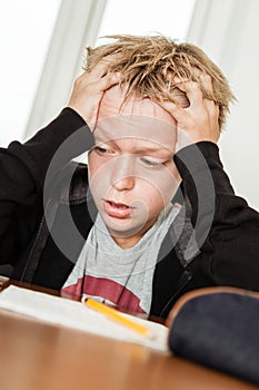 Anxious child struggling to complete homework photo