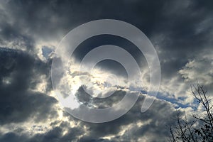 anxious dramatic landscape, echanges in weather, blue sky with white and dark clouds, concept of transcendence, Heaven and