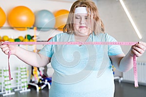 Anxious Obese Woman with Tape Measure